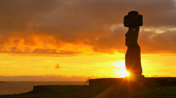 istock SILHOUETTE: Dark clouds gather above the historic moai statue by the shore. 1185022459