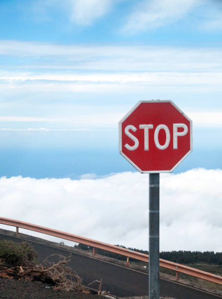 istock Stop road sign in high mountain road. 1185024164