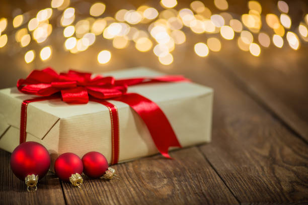 istock Christmas Gift on Old Plank and Christmas lights 1185025429