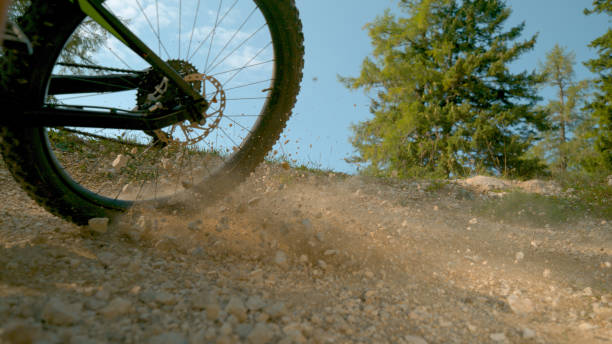 istock CLOSE UP: Unrecognizable cyclist brakes hard while speeding along a gravel track 1185027677
