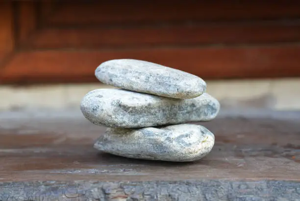 Photo of balanced stones on wooden background