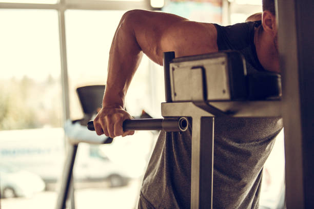 istock Unrecognizable male athlete doing arm work outs at the gym 1185030374