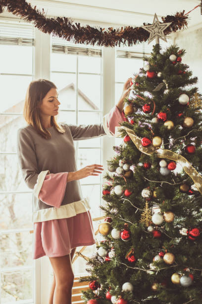 istock Woman decorating the Christmas tree 1185032329