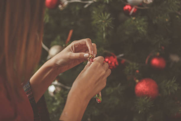 istock Close up of unrecognizable woman decorating Christmas tree 1185032473