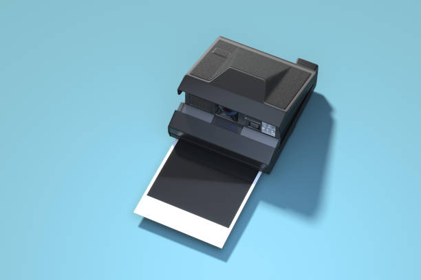 istock Instant photo camera with blank photo isolated on blue background. 3d rendering. 1185036255