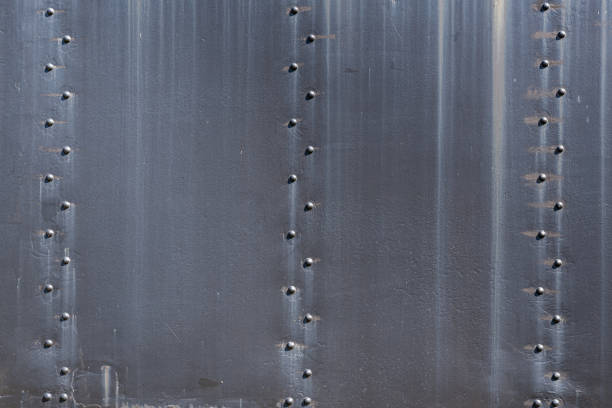 istock Black Steel Plates and Rivets Background 1185037383