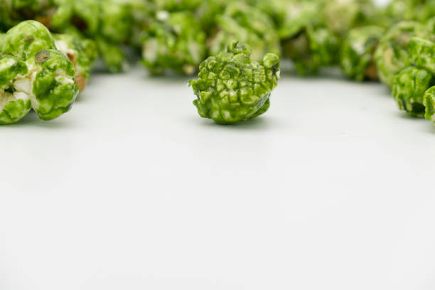 Lush of Japanese matcha green tea popcorn isolated on white background, Popular snack with favorite movie