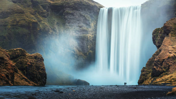 Couple of tourist near Skogafoss stock photo