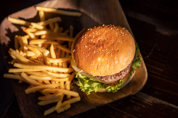 istock tasty hamburger and fried potatoes 1185037893