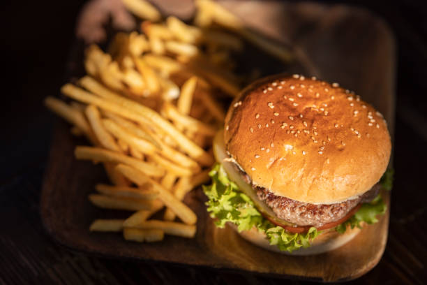 istock tasty hamburger and fried potatoes 1185038021