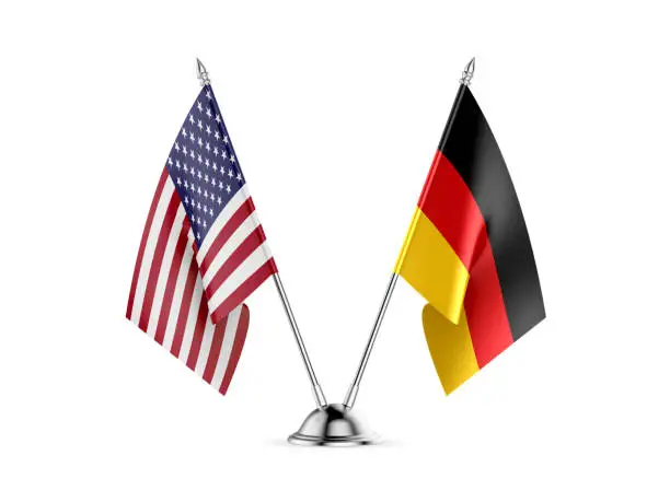 Photo of Desk flags, United States  America  and Germany, isolated on white background. 3d image