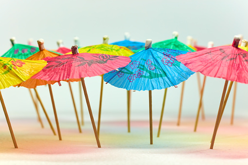 Several colorful paper umbrellas stand close together.