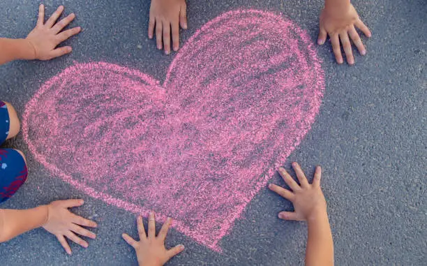 Photo of Children's drawings on the asphalt with chalk. Selective focus.