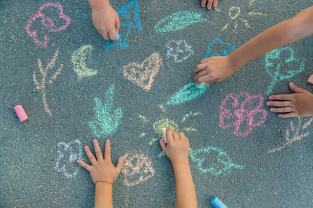 istock Children's drawings on the asphalt with chalk. Selective focus. 1185046263