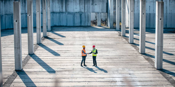 istock High Angle View of Construction Site Coworkers Shaking Hands 1185046276