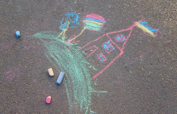 istock Children's drawings on the asphalt with chalk. Selective focus. 1185046279