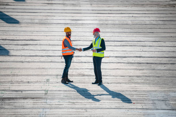 istock Young African Construction Site Foreman Greeting Manager 1185046282