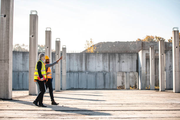 istock Young African Construction Foreman Leading Site Walk-Through 1185046293