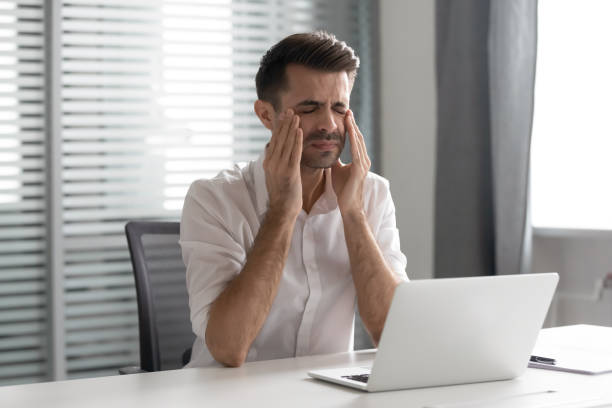 istock Stressed frustrated businessman suffer from strong headache attack at workplace 1185049605