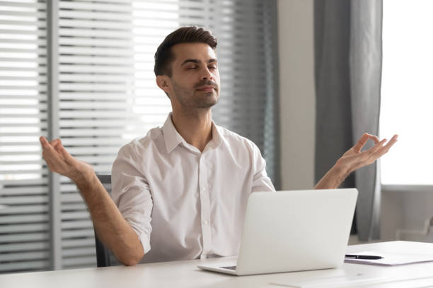 istock Calm mindful businessman taking break meditate sit at office desk 1185049607