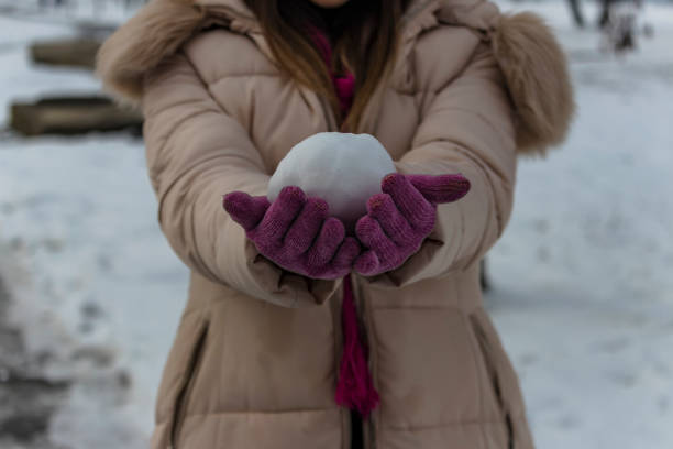 istock Woman with a Snowball 1185049648