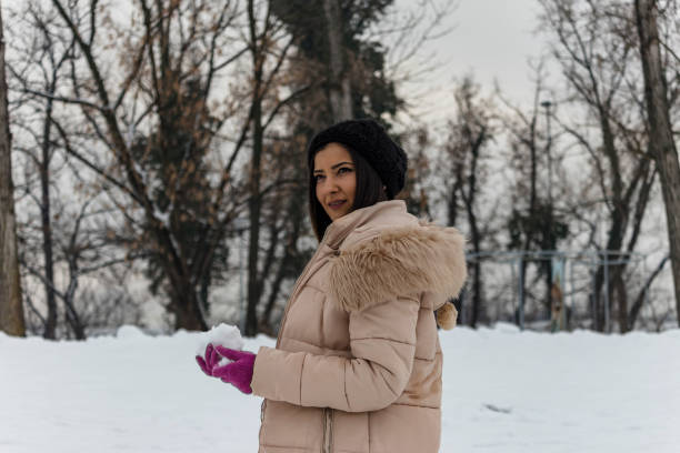 istock Woman with a Snowball 1185051051
