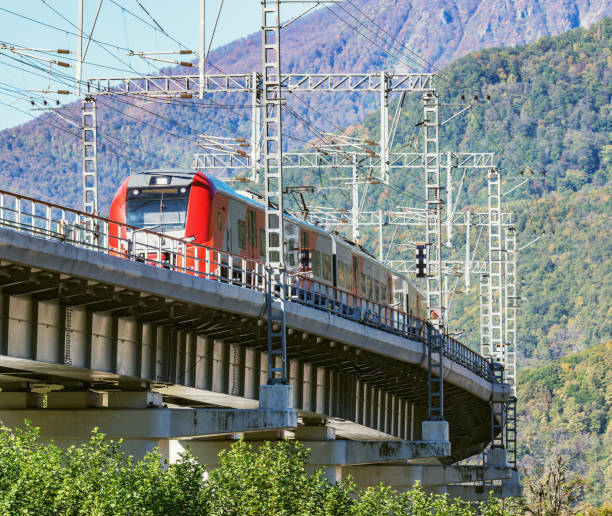 istock Passenger train from Sochi moves on the bridge.. Krasnaya Polyana. 1185051067