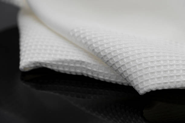 istock Macro shot texture pattern of folded white towel kitchen fabric 1185051984