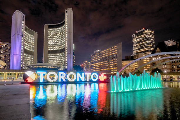 Toronto Sign in Nathan Phillips Square Nathan Phillips Square at night with Toronto Sign and City Hall Building toronto stock pictures, royalty-free photos & images