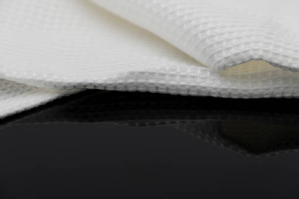 istock Macro shot texture pattern of folded white towel kitchen fabric 1185052480