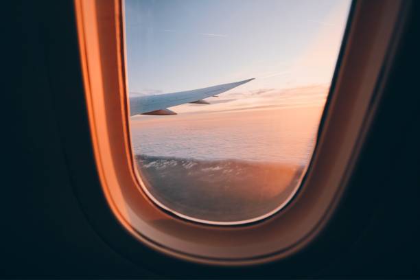 istock Beautiful sunset look through airplane window 1185052540