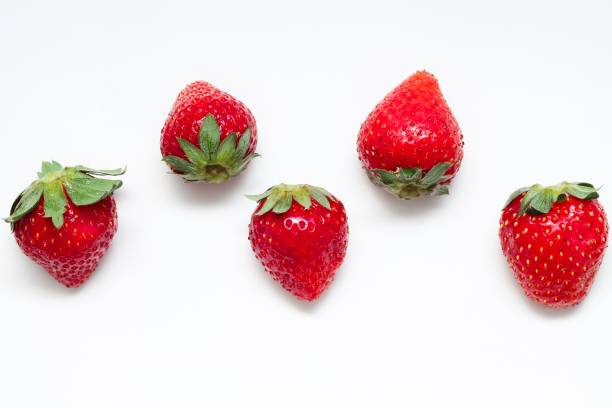 istock Isolated red strawberries on white background 1185054366