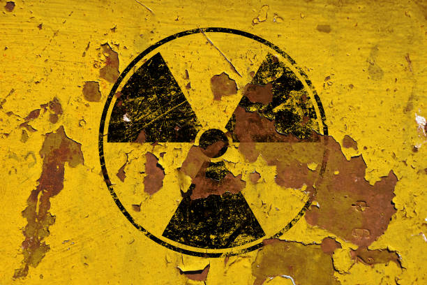istock Black radioactive sign over yellow background 1185056291