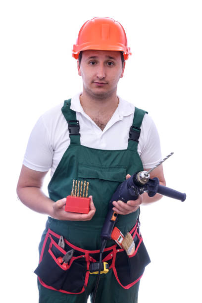 istock Worker with drill machine and supplies isolated on white 1185062356