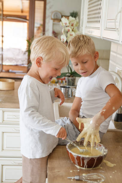 istock Boys preeparing bake homemade pie in kitchen. Two brothers cooki 1185063852