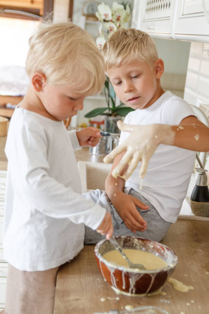 istock Boys preeparing bake homemade pie in kitchen. Two brothers cooki 1185064720