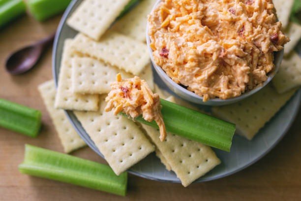 istock Pimento cheese dip with crackers and celery sticks. Overhead view. 1185068682