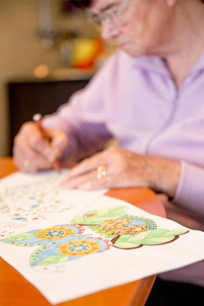 istock Senior Woman Coloring Illustrations at Home 1185069811