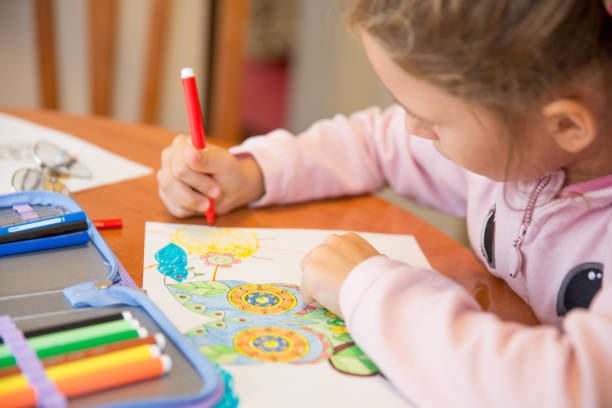 A beautiful girl sitting at home and doing homework