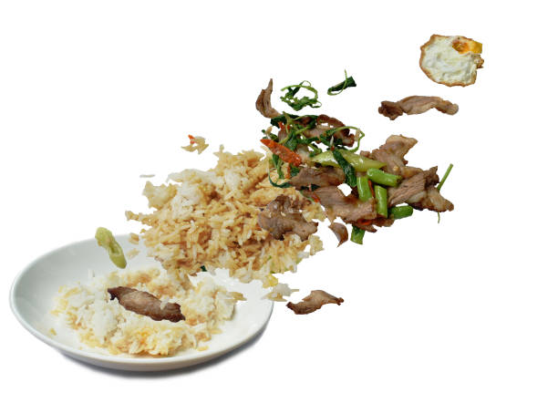 spicy stir fried slice grilled pork with chili and basil leaf topping egg floating on white dish