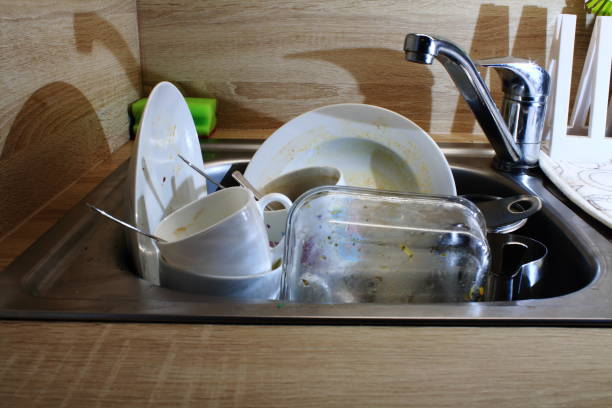 istock dirty dishes in the sink 1185072486