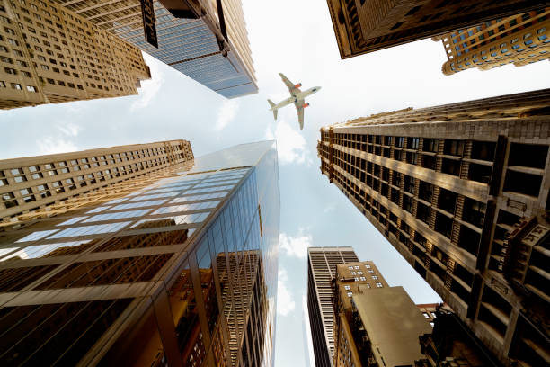 istock Airplane flying over skyscrapers, Lower Manhattan, NYC. 1185074750