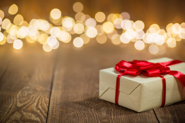 istock Christmas Gift on Old Plank and Christmas lights 1185075532