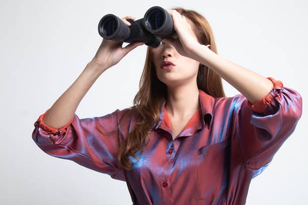 istock Young Asian woman with binoculars. 1185079248