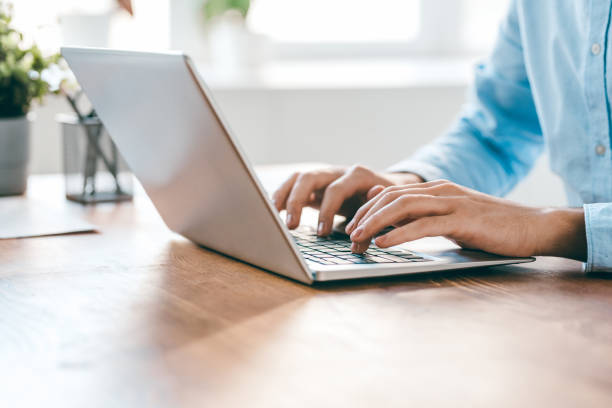 istock Hands of young contemporary office manager over laptop keypad during work 1185081055