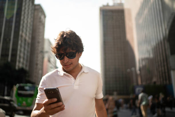 istock Man walking and using smartphone at city 1185082084