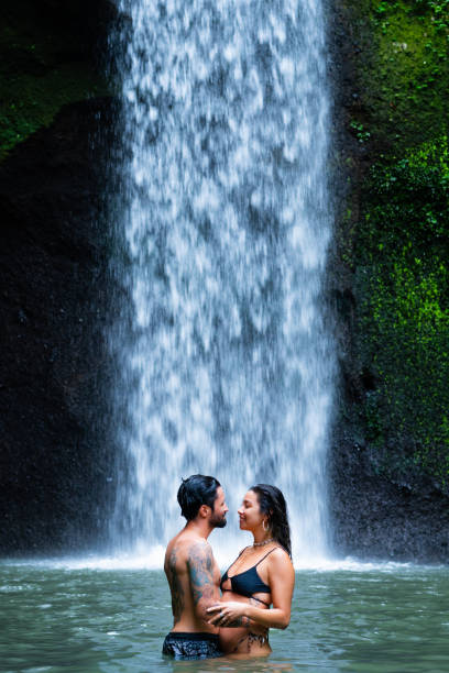 istock Young couple higging in a waterfall 1185082494