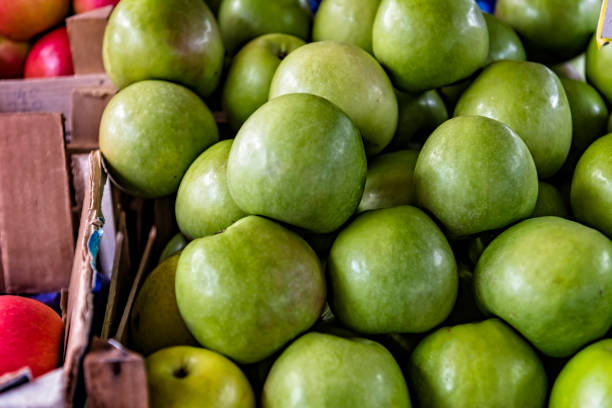 Close-up View at the Fresh and Delicious Green Apples at the Farmers Market. An Apple is a Sweet, Edible Fruit Produced by an Apple Tree (Malus Pumila).