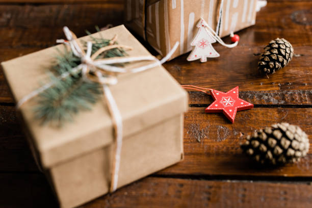 istock Christmas decorations, pine cones and packed giftbox with conifer on top 1185084123
