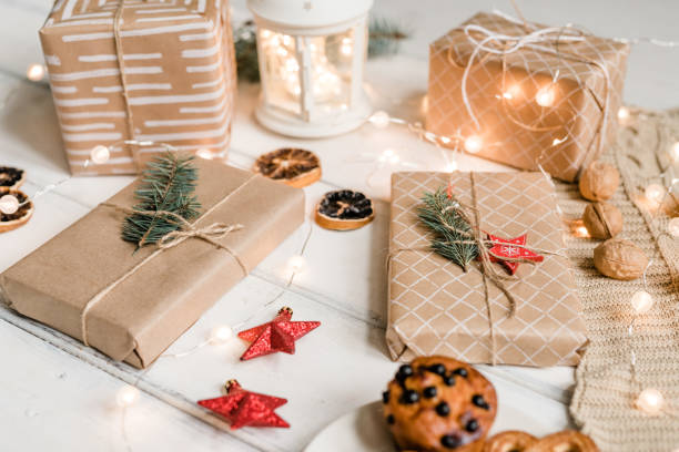 istock Packed gifts among decorative red stars, walnuts, sparkling garlands on table 1185084179